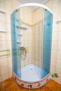 a shower with a glass enclosure in a bathroom at Piovra in Vama Veche +29 photos