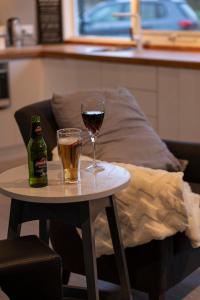 a glass of wine and a bottle on a table at Platypus Waters B&B in Smithton