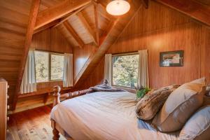 a bedroom with a bed in a room with wooden walls at Charlies Cabin - Mt Lyford in Mt Lyford