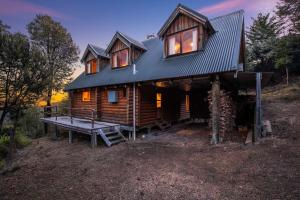 a log cabin with a bench in front of it at Charlies Cabin - Mt Lyford in Mt Lyford +21 photos
