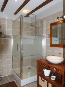 a bathroom with a glass shower and a sink at Domaine de Bonnet in Castelnau-de-Lévis
