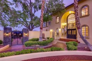 an exterior view of a house with a gate and trees at Villa Gordal - Enormous Villa in Las Vegas with 39 Sleeps in Las Vegas