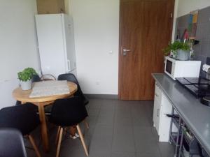a small kitchen with a table and a microwave at Hostel Załogowa in Gdańsk