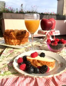 a table with a plate of food and a glass of orange juice at B&B Independente in Assago