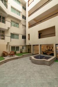 a courtyard of a building with a hot tub at Halcyon Hotel Residences - Bangalore in Bangalore