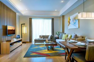 a living room with a couch and a table at Shama Heda Serviced Apartment in Hangzhou