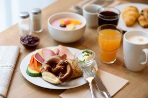 a table with a plate of breakfast food and drinks at Holiday Inn Express Göttingen by IHG in Göttingen