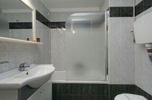 a bathroom with a sink and a shower at Hotel Nefeli in Volos
