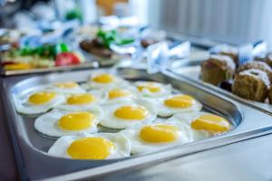 a tray filled with eggs on top of bread at Zhemchuzhina Grand Hotel in Sochi