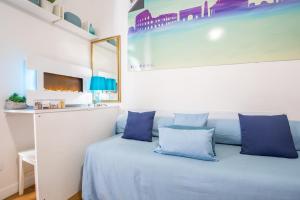 a bedroom with a blue bed with blue pillows at Smart Lodgings Plus in Rome