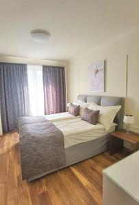 a bedroom with a large bed and a window at Aqua Viva Spa Hotel in Velingrad