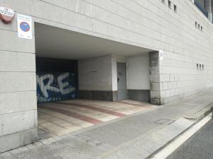 an empty parking garage with a wall with graffiti at Sani apartment by People Rentals in Bilbao