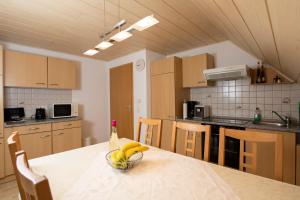 a kitchen with a table with a bowl of bananas on it at Ferienwohnung Forster in Moosbach