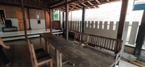 a wooden bench sitting inside of a building at Homestay Kurnia in Bantul