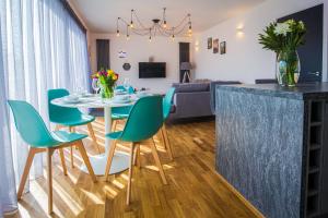 a kitchen and living room with a table and chairs at Broadstairs Apartments in Broadstairs