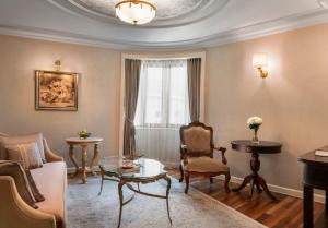a living room with a couch and a table at Rixos Pera Istanbul in Istanbul