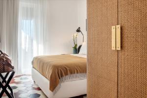 A bed or beds in a room at Magnolia Boutique Rooms
