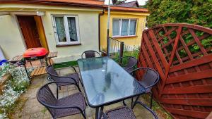 a table and chairs sitting on a patio at Domek nad morzem Wisełka in Wisełka