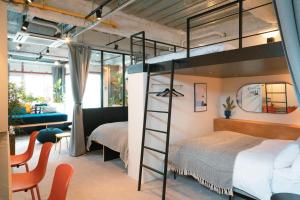 a loft bed in a room with a bedroom at illi Esu Nakano in Tokyo