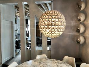 a large chandelier hanging over a table in a room at duplex top central Marais in Paris +25 photos