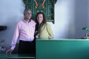 a man and a woman standing next to a desk at Offenthaler Hof in Dreieich