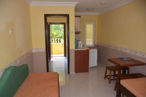 a room with a kitchen and a dining room at Club Sunset Apartments in Marmaris