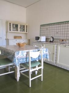 a kitchen with a table and chairs in a kitchen at Don Vito in Racale
