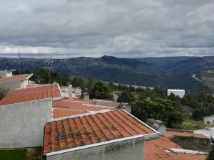 a view of the mountains from the roofs of houses at Refúgio do Douro Guest House in Bemposta