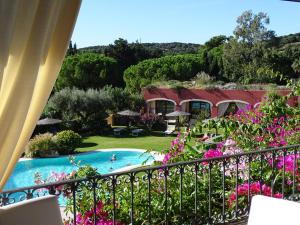 a view from the balcony of a resort with a swimming pool at Hotel Mariposas in Villasimius