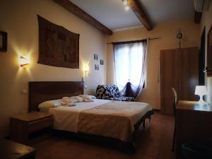 a bedroom with a bed and a chair and a window at Cà Tron Apartment next to Rialto bridge in Venice