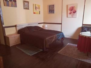 a bedroom with a bed and a wooden floor at Residencia Los Conejos - Bike & Motorbike in Las Palmas de Gran Canaria