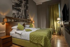 Postel nebo postele na pokoji v ubytování Badagoni Boutique Hotel Rustaveli