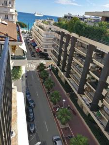 a view of a street in a city with buildings at Nice apartment last floor with terrace and clear view on the sea in Cannes +7 photos
