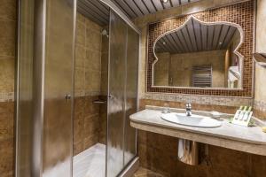 a bathroom with a sink and a mirror at Diplomat Plaza Hotel & Resort in Lukovit