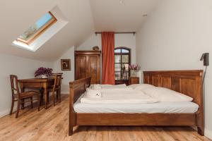 a bedroom with a bed and a table and a desk at Tabun in Gdańsk