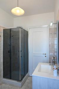 a bathroom with a shower and a sink at Lyceum Flat in Olbia