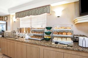 a kitchen with a counter with many different types of food at La Quinta Inn by Wyndham El Paso East Lomaland in El Paso