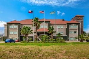 a building with two flags in front of it at La Quinta by Wyndham Alvin in Alvin