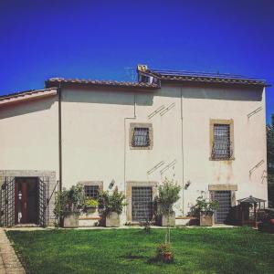 a white house with windows and a yard at Alloggio Turistico Vigna Clara in Viterbo
