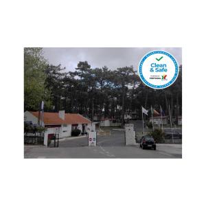 a picture of a parking lot with trees in the background at Parque de Campismo Orbitur Valado in Nazaré