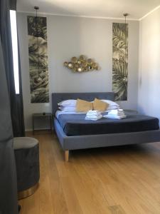 a bedroom with a bed with a blue bedvisor at Belsiana Luxury Apartment in Rome