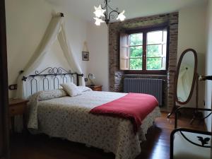 a bedroom with a bed and a mirror and a window at Casa Bama in Bama +44 photos