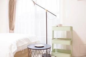 a bedroom with a green book shelf next to a bed at Hotel Shu in Tokyo
