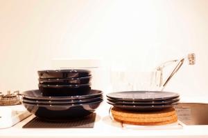 a stack of black toilets sitting on top of a counter at Hotel Shu in Tokyo