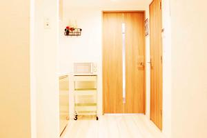 a kitchen with a stove and a microwave at Hotel Shu in Tokyo