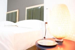 a lamp on a table next to a bed at Hotel Shu in Tokyo