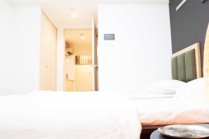 a bedroom with a mirror and a bed at Hotel Shu in Tokyo