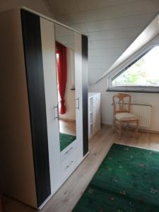 a room with a door and a green rug at Goslar Ferienwohnung im Harz in Neuwallmoden