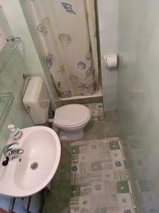 a bathroom with a white sink and a toilet at Villa Radić in Makarska