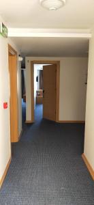 an empty room with a door and a hallway at Saatlı Hotel in Çeşme